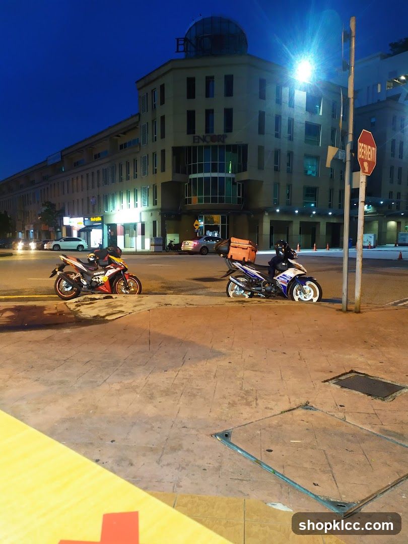 Motorcycles parked on sidewalk at night