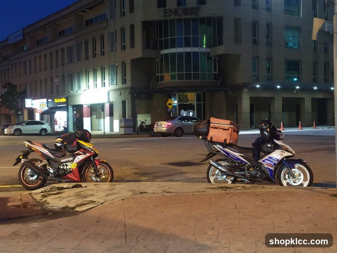 Motorcycles parked on sidewalk at night