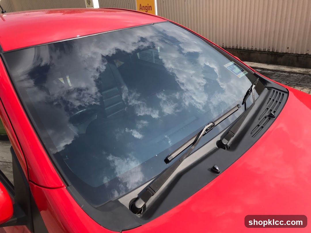 Red car windshield reflection