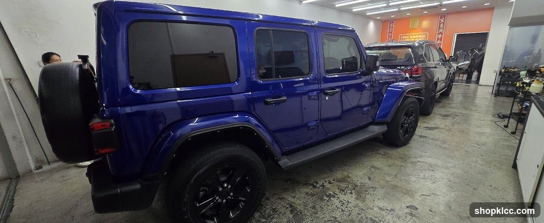 Blue Jeep Wrangler in a Garage