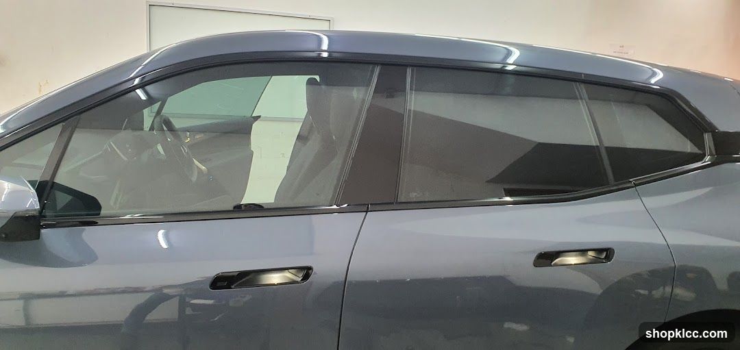 Side view of a light blue car with tinted windows