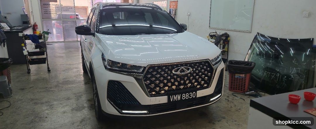 White SUV in a workshop or garage