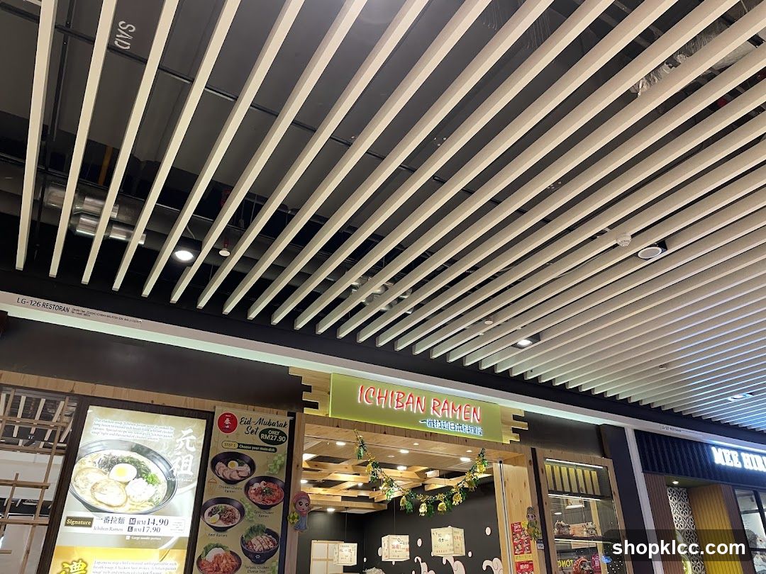 The storefront of Ichiban Ramen, a Japanese restaurant. The entrance is decorated with festive lights. To the left of the entrance is a menu board displaying ramen dishes.