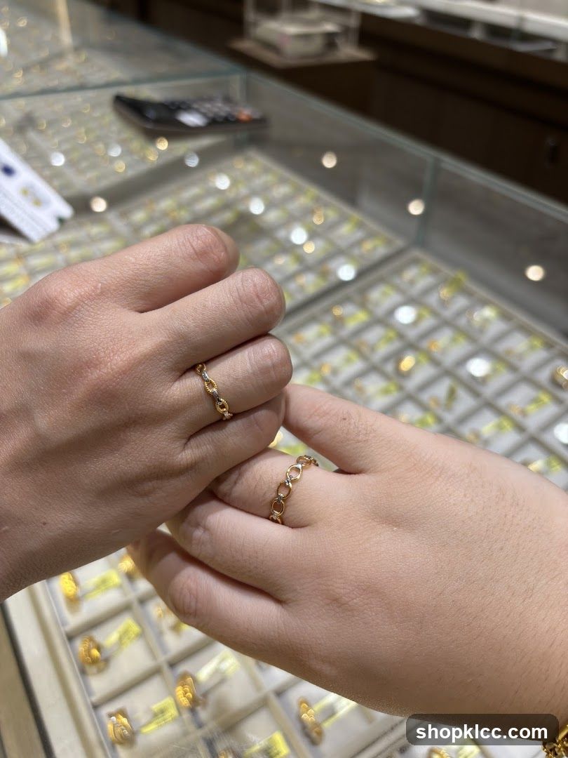 Two hands wearing rings in a jewelry store
