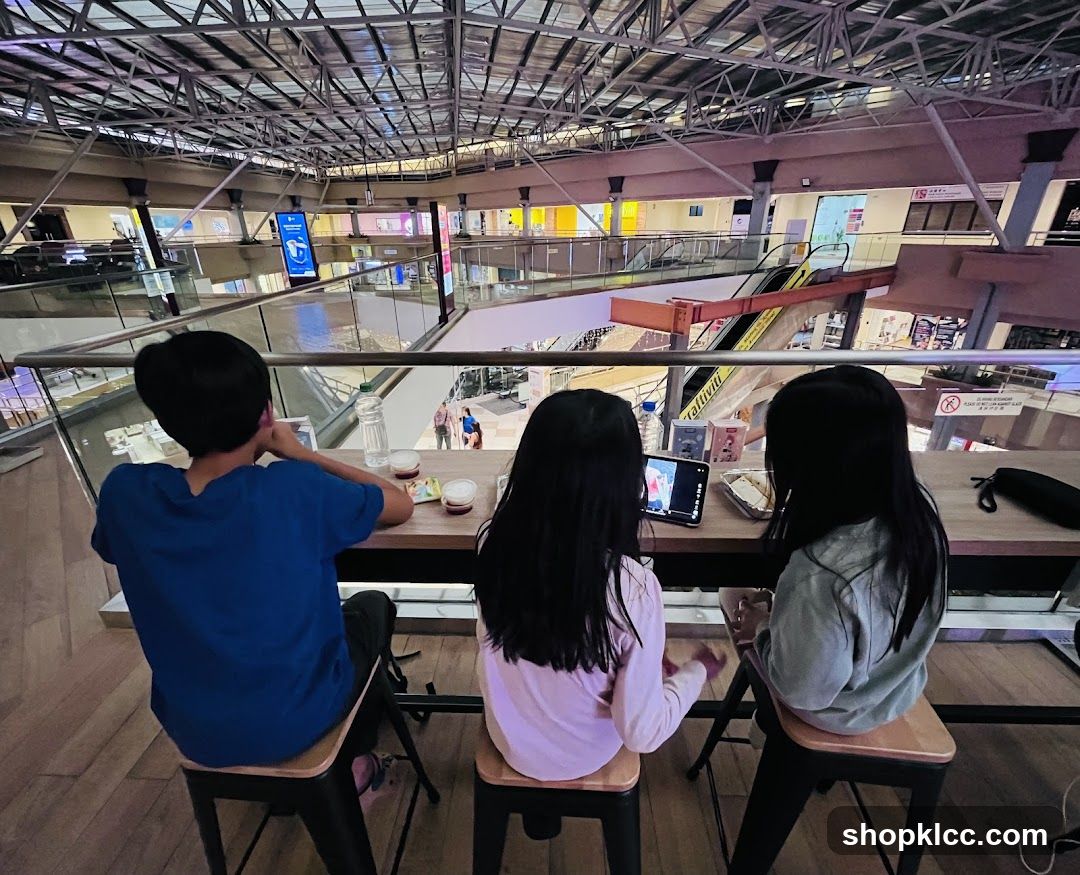 People at a mall food court table