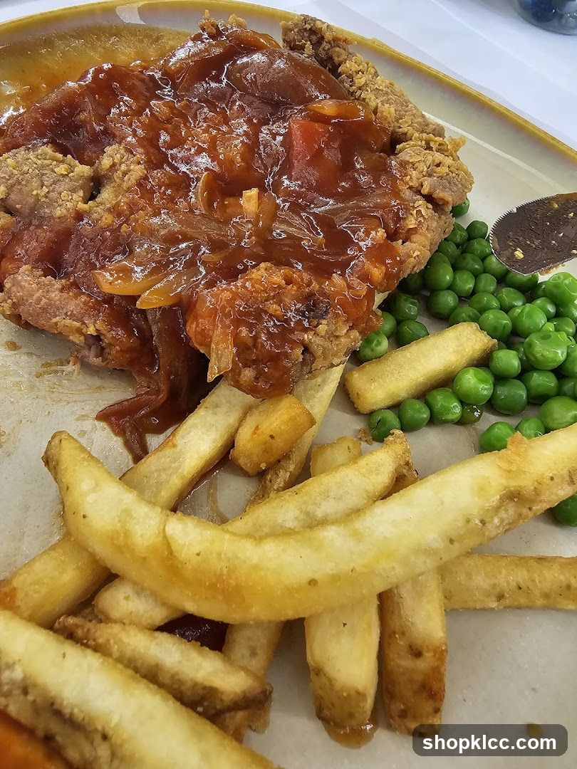 Chicken dish with fries and peas