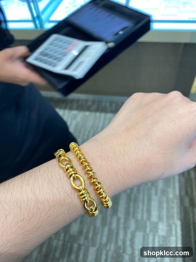 Two gold bracelets on a wrist