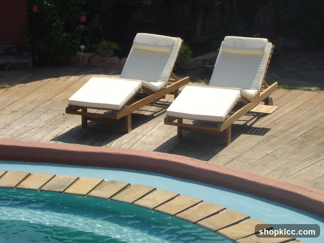Two lounge chairs by a pool