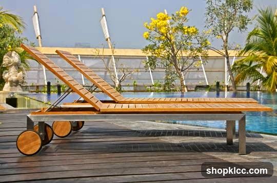 Wooden lounge chairs by a pool