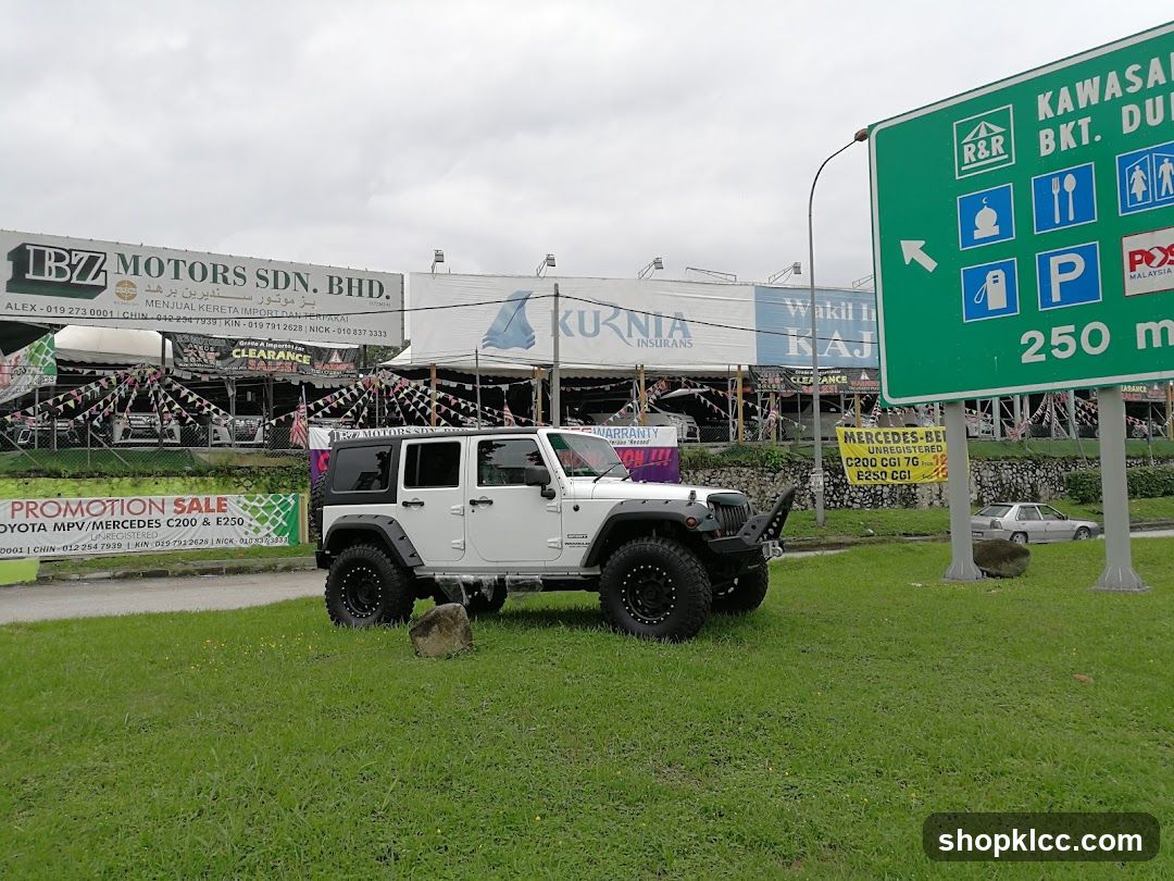 Jeep Wrangler in parking lot near commercial area