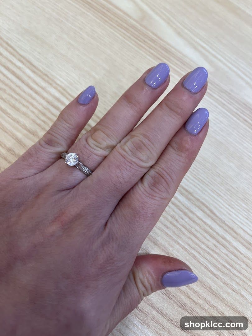 Hand with purple nail polish and rings