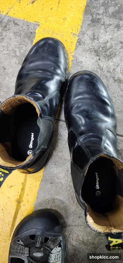 Worn Black Boots on Concrete Floor