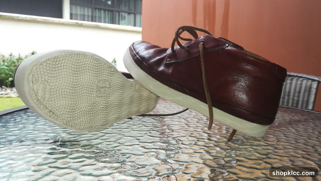 Maroon Leather Shoes on Glass Table