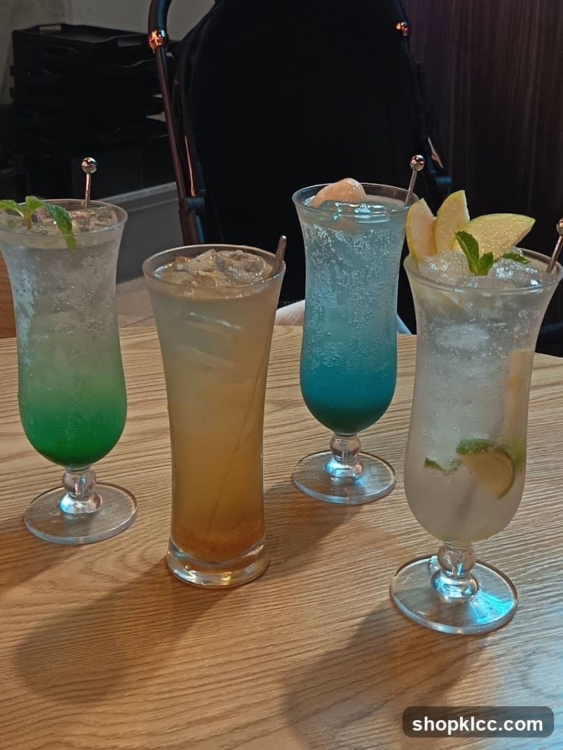 Four Colorful Drinks on a Wooden Table