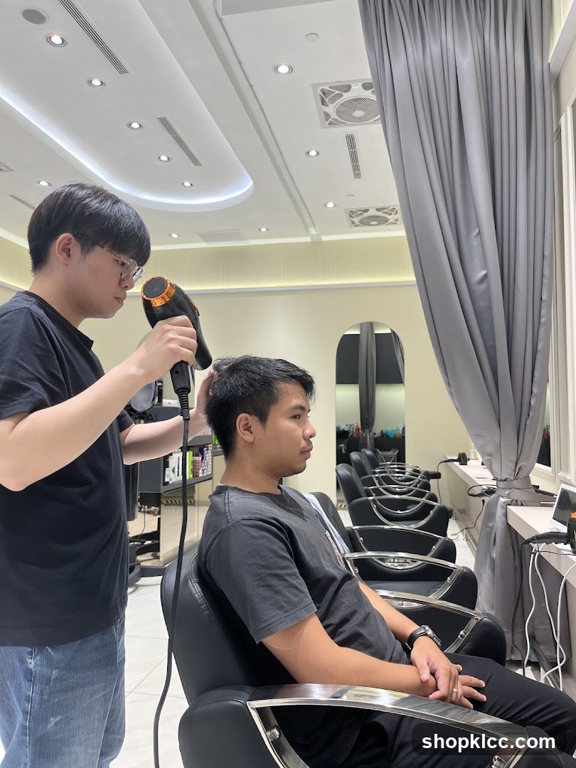 Hairdresser drying client's hair