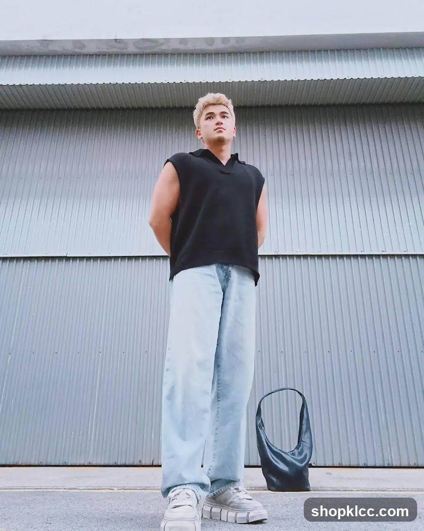 Man in black vest and light blue jeans