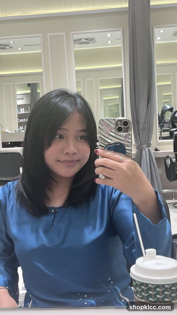 Woman taking a selfie in a salon