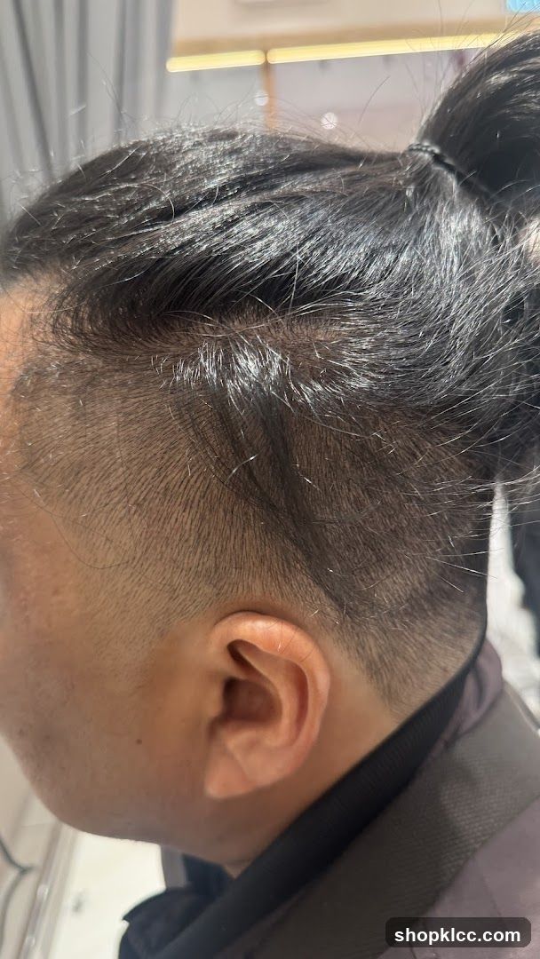 Close-up of a person's hair and ear