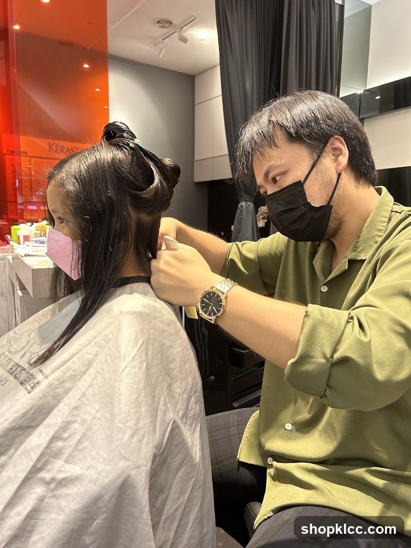 Hairdresser cutting client's hair