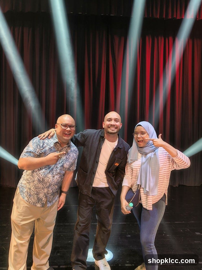 Three people on stage with spotlights