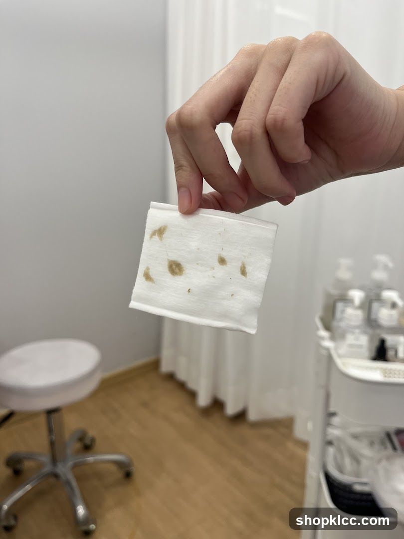 Hand holding stained wipe in salon