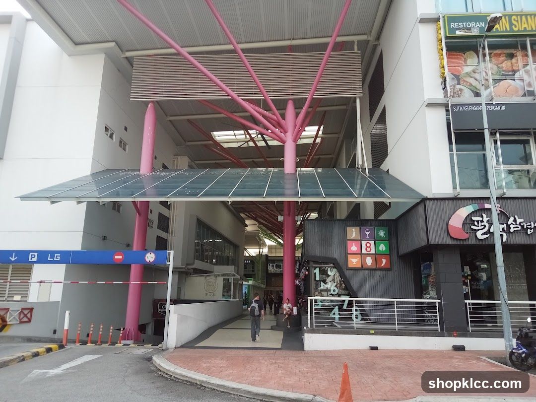 Entrance to a commercial complex with pink structural beams