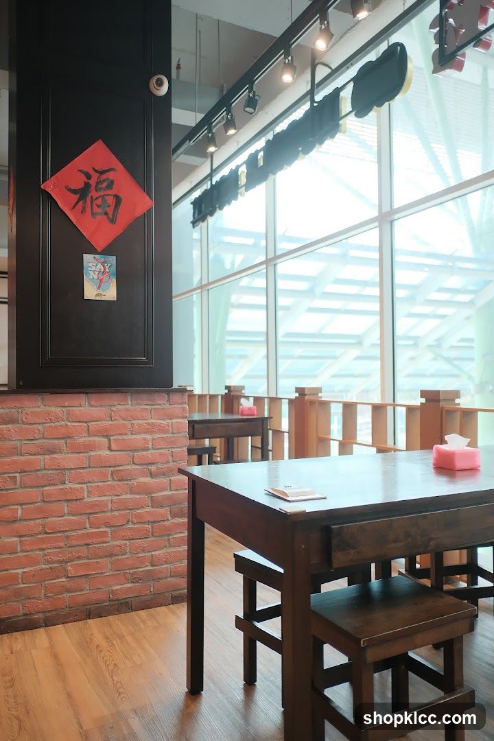 Interior of a restaurant with wooden tables and brick wall