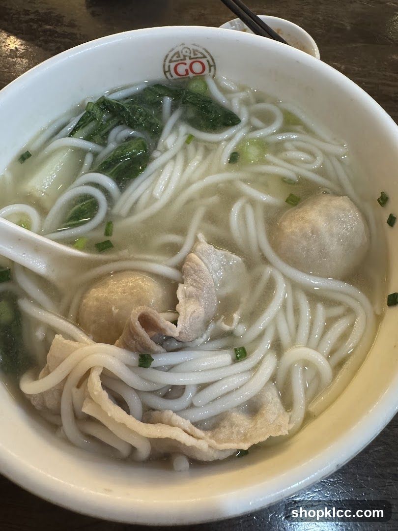 Bowl of Noodle Soup with Meatballs and Greens