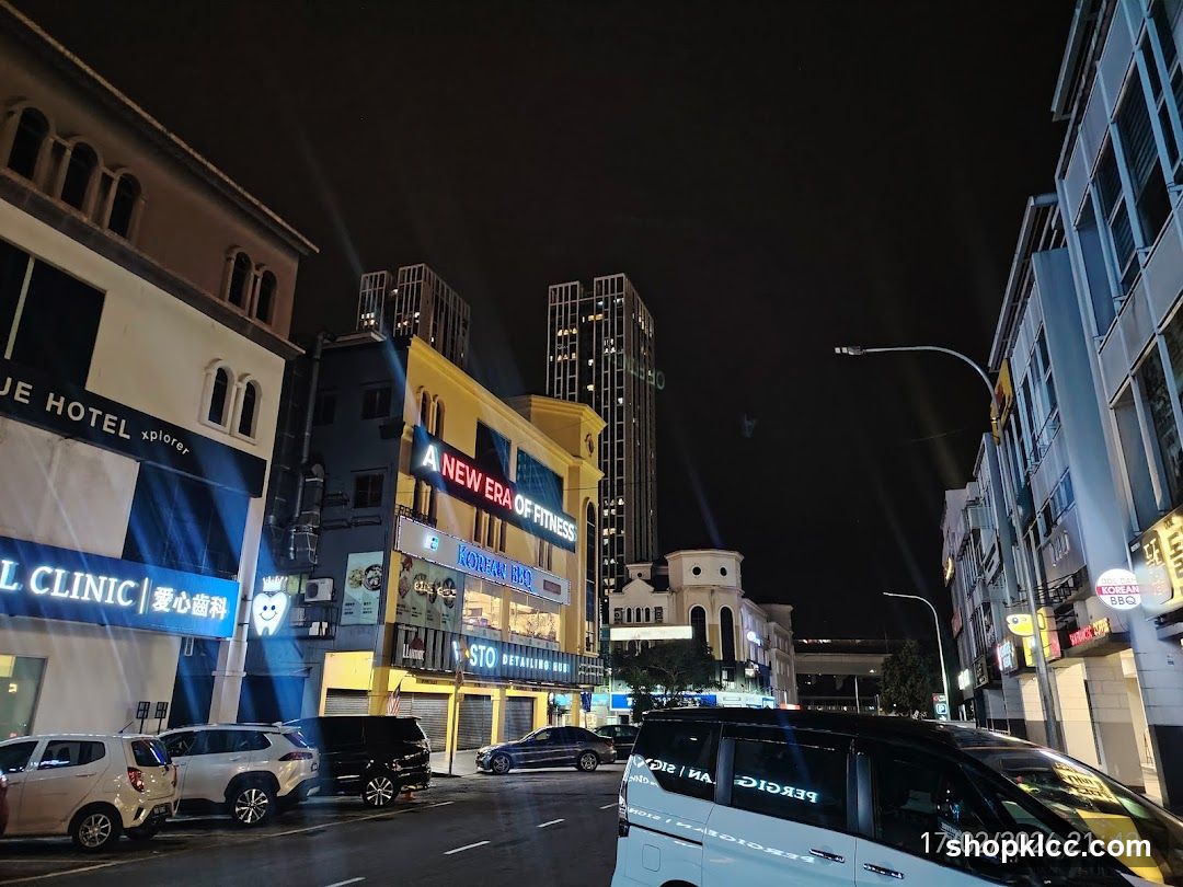 Night street scene with illuminated buildings