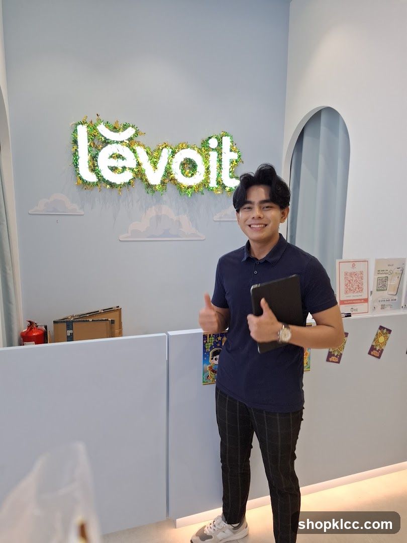 Man giving a thumbs up in front of a Levoit sign