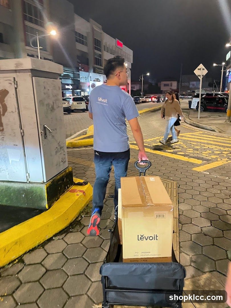 Man pulling a cart with boxes