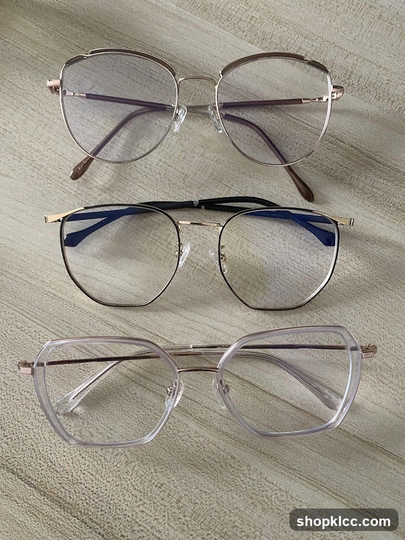 Three pairs of eyeglasses on a textured surface