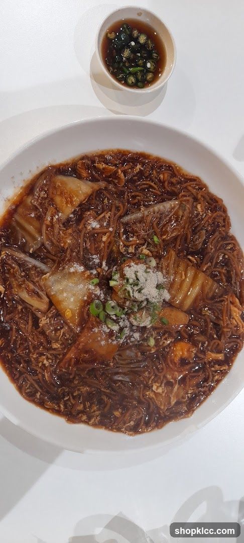 Bowl of Noodles with Sauce and Garnish