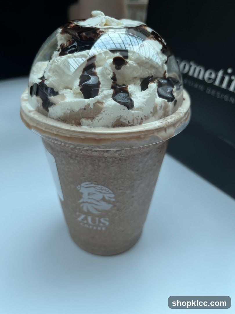 Zus Coffee Drink with Whipped Cream and Chocolate Drizzle