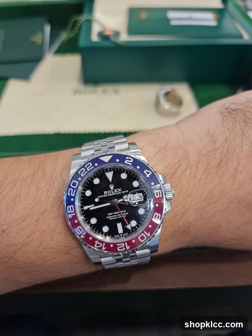 Rolex GMT-Master on wrist with green Rolex box in background