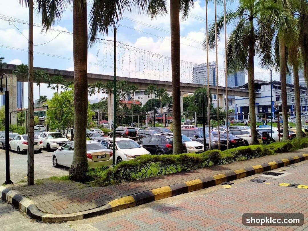 Parking Lot with Palm Trees and Elevated Train Track