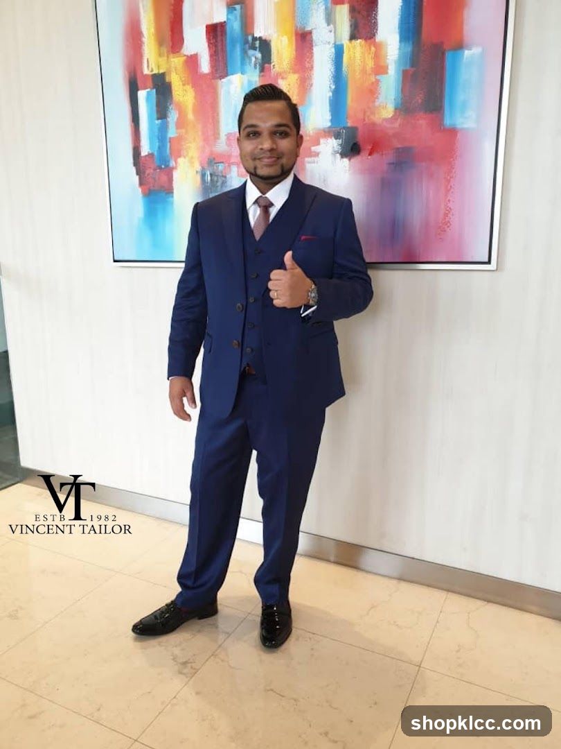 Man in a blue suit giving a thumbs up