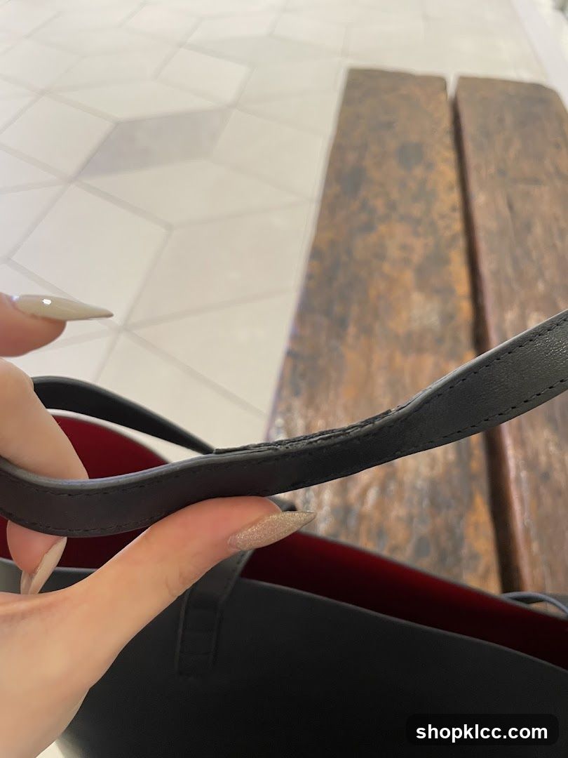 Close-up of a black tote bag handle