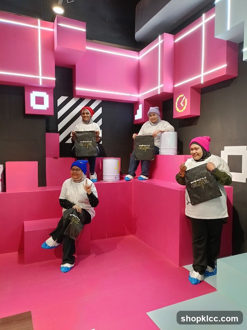 People posing in a pink and black geometric room