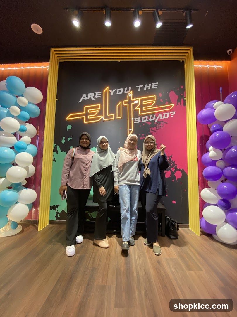 Four women posing in front of a neon sign
