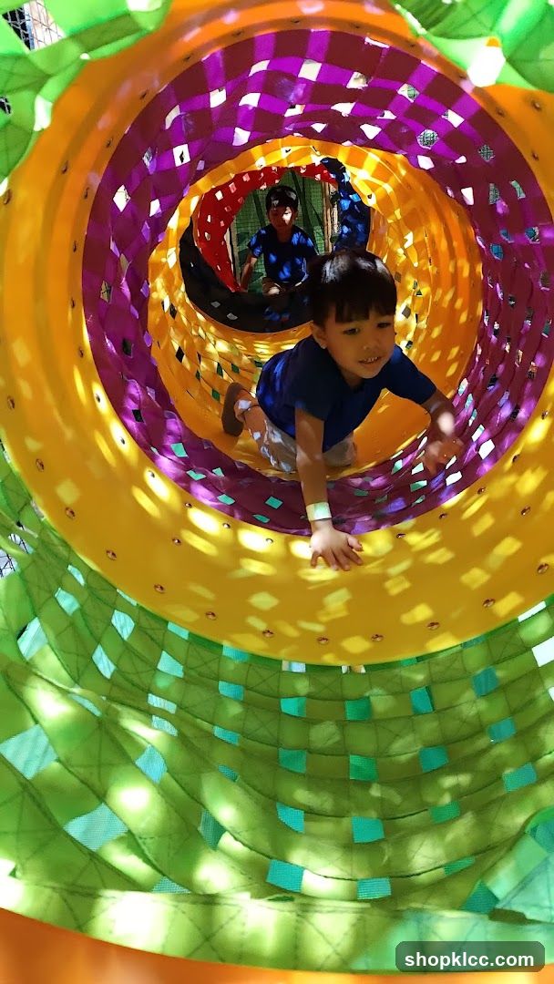 Children playing in a colorful tunnel