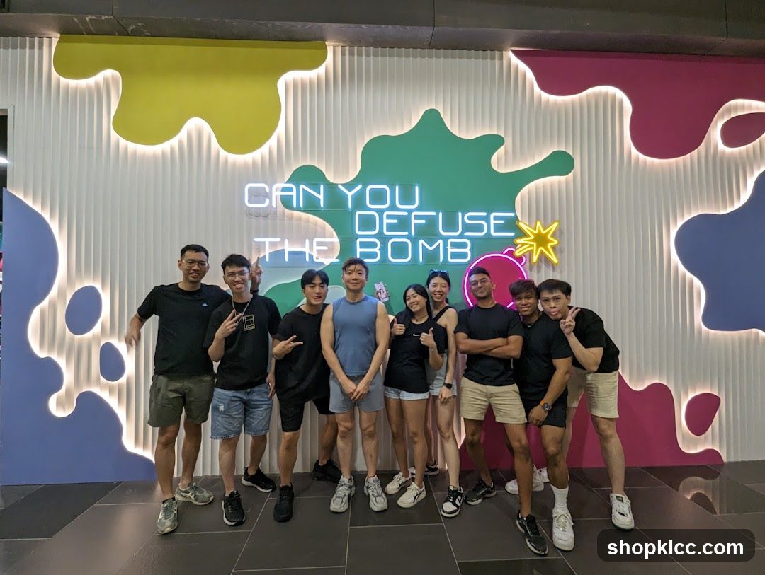 Group Posing in Front of Neon Sign
