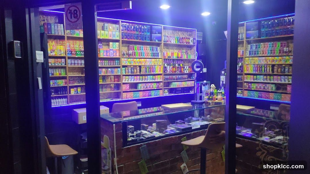 Interior of a brightly lit convenience store with neon lighting and glass display counters.