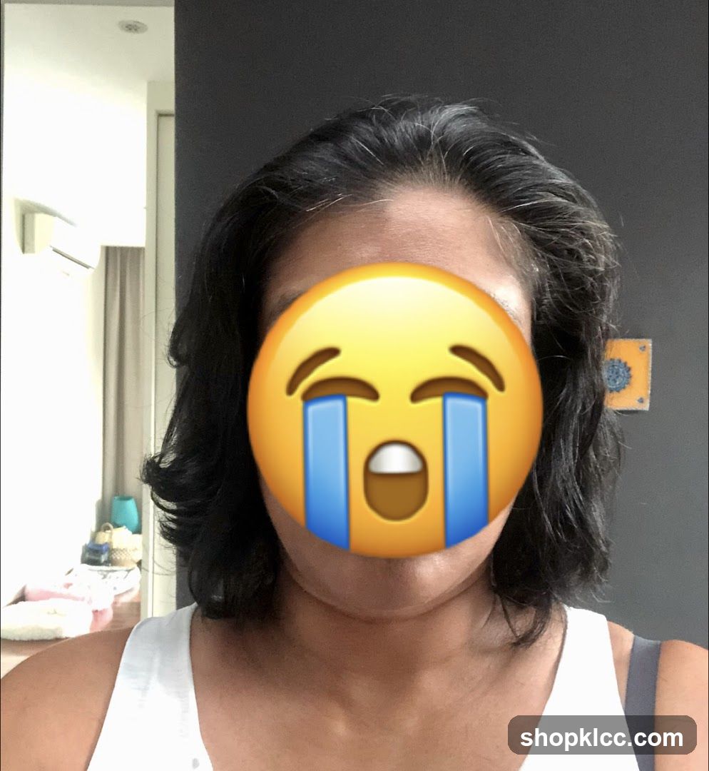 Person with crying emoji covering face
