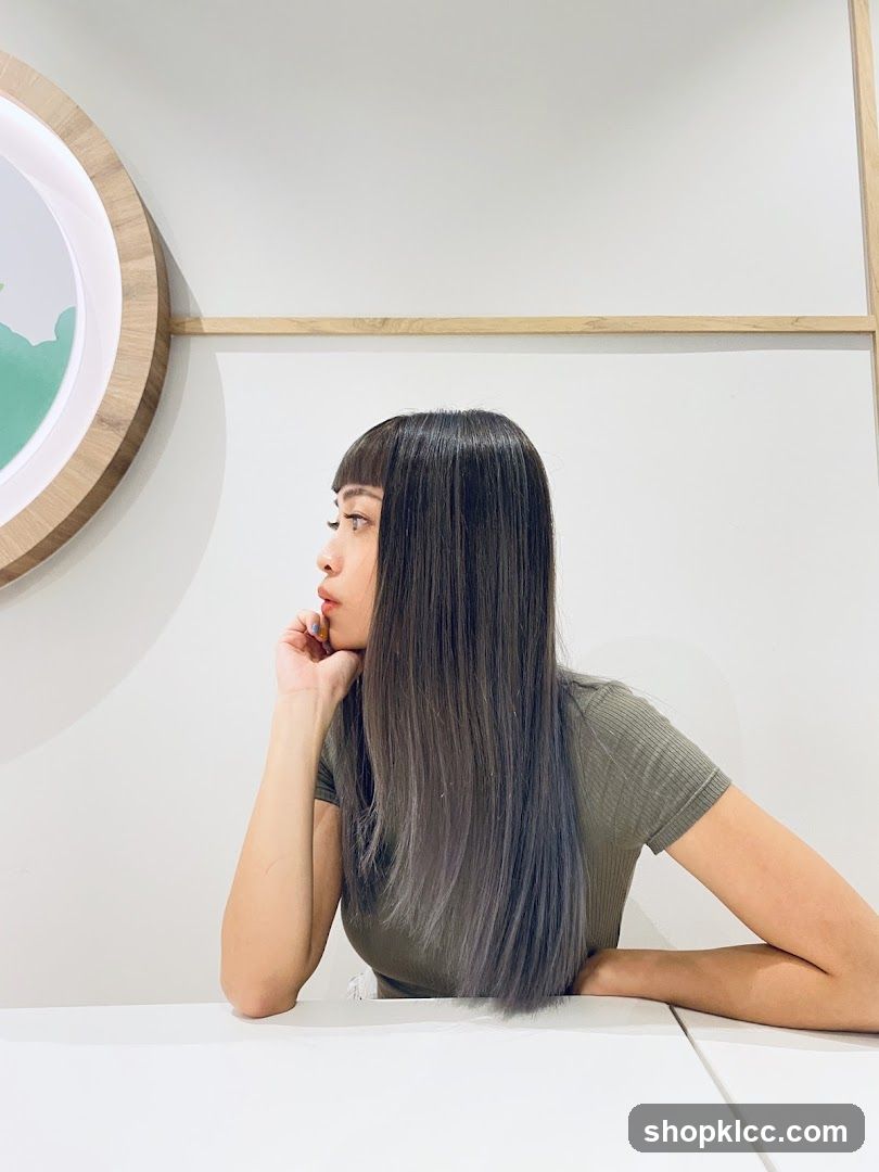 Woman with long dark hair in a salon or cafe interior