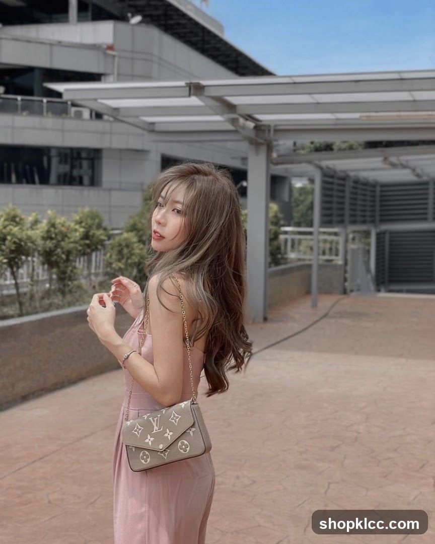 Woman in pink dress with LV bag