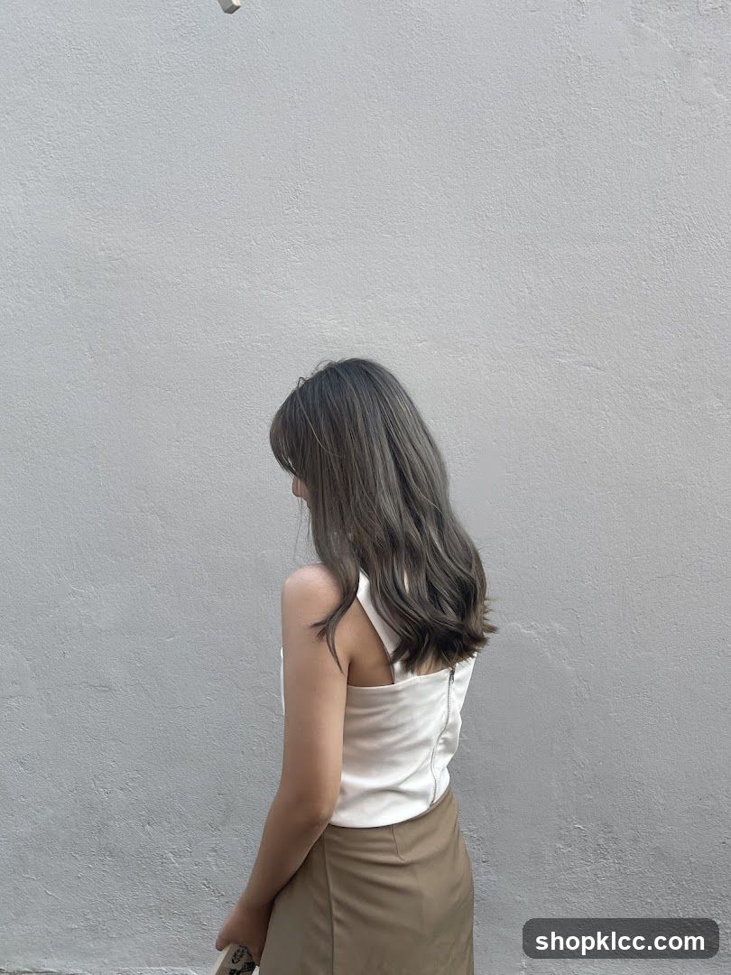 Woman with Grey Hair Standing Against a Wall