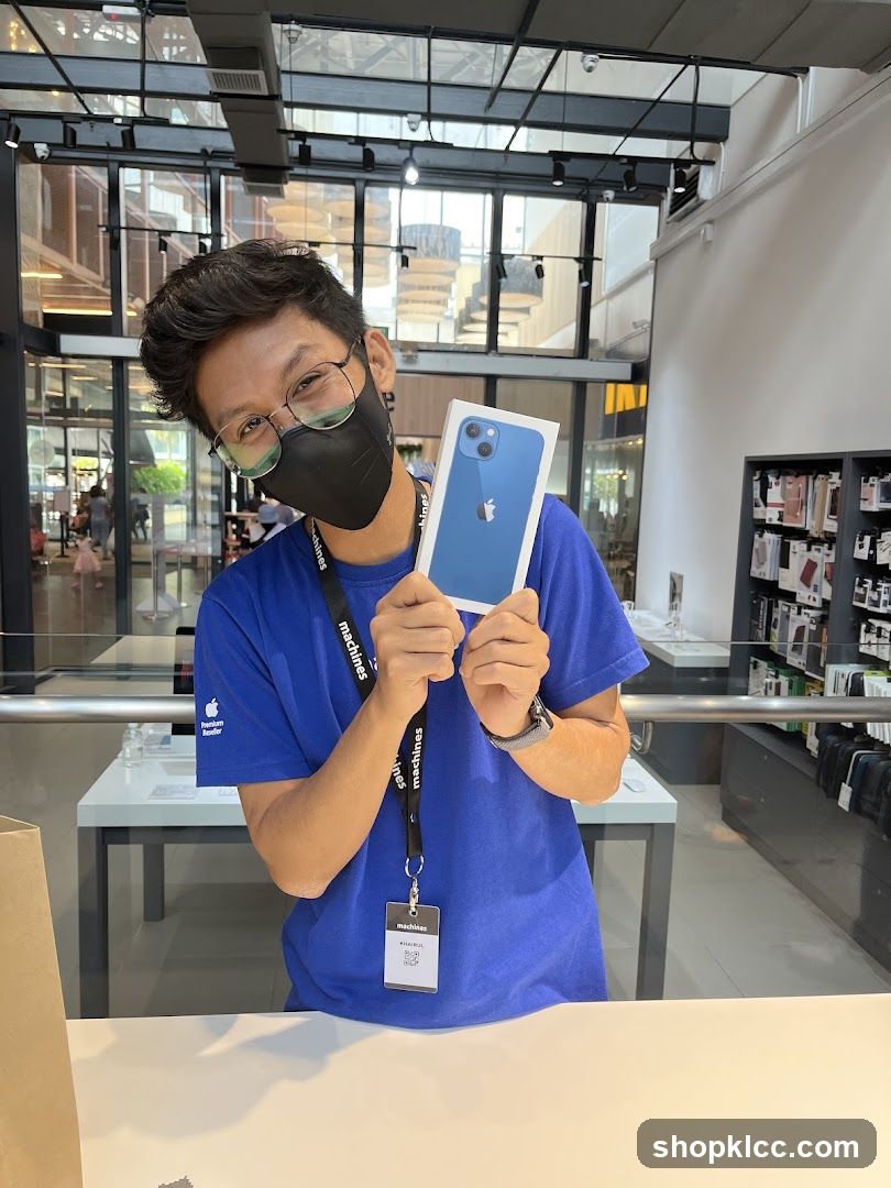 Staff holding iPhone box in store
