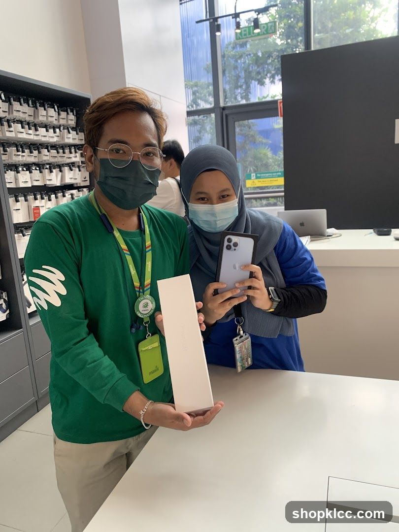 Staff showing iPhone box in store