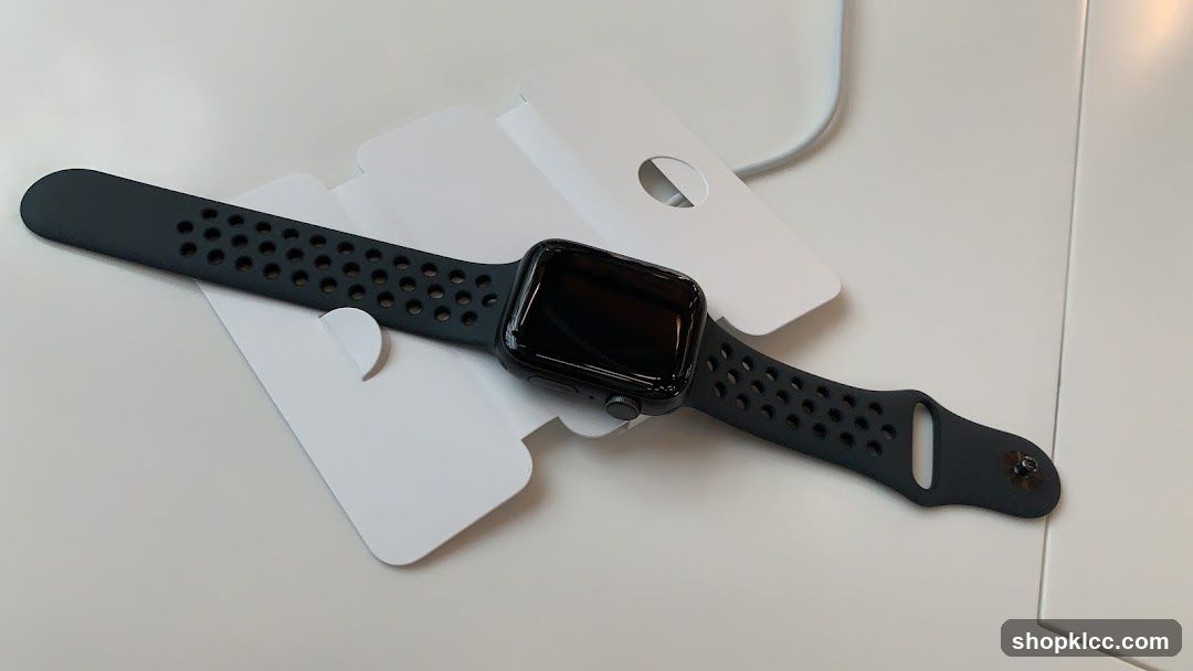 Apple Watch with perforated band on white surface